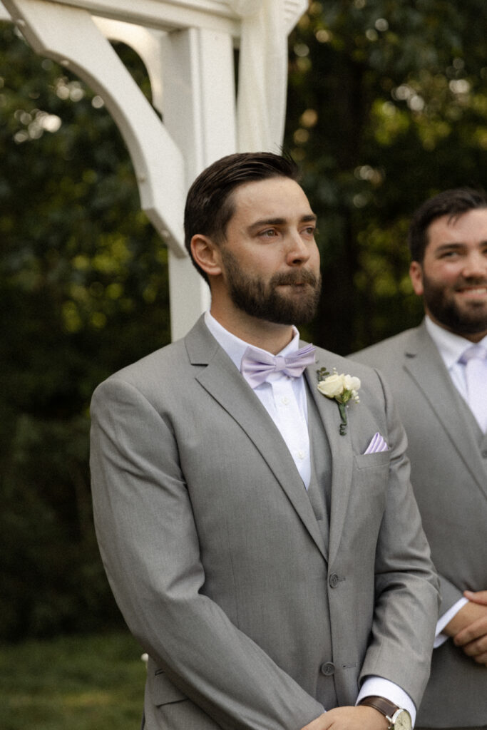 Groom cries as bride walks down the aisle.