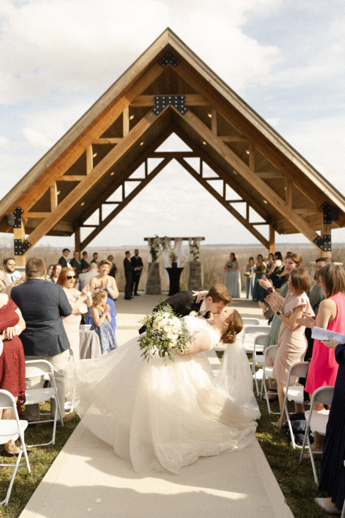 Dip Kiss in the center aisle at Missouri Wedding Venue the Ridge